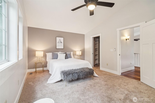 carpeted bedroom featuring lofted ceiling, a ceiling fan, and baseboards