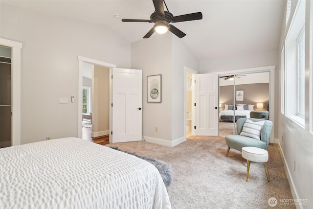 bedroom with a closet, carpet, ceiling fan, baseboards, and lofted ceiling