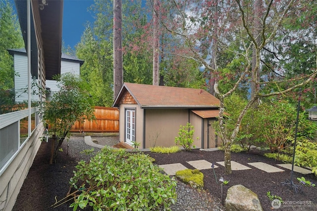 view of outdoor structure featuring an outbuilding and a fenced backyard