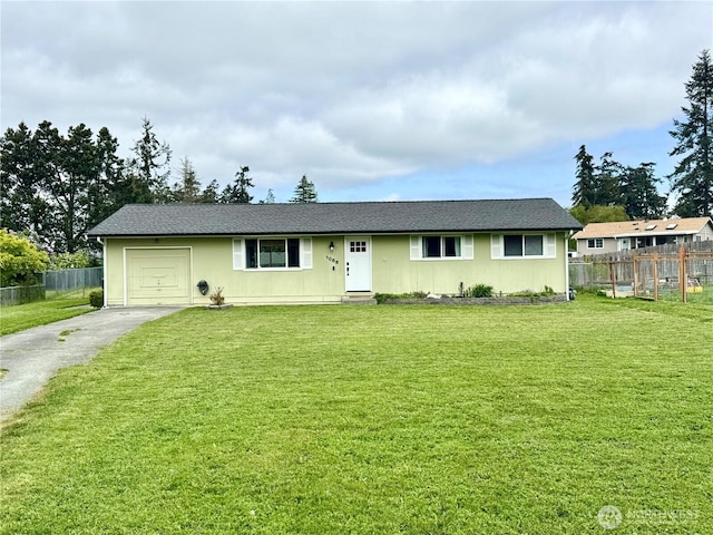 ranch-style house with a garage, fence, aphalt driveway, and a front lawn