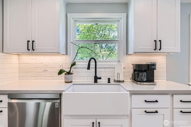 kitchen featuring white cabinetry, a sink, light countertops, dishwasher, and backsplash