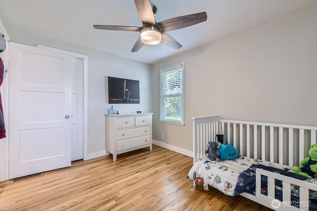 bedroom featuring light wood finished floors, ceiling fan, and baseboards