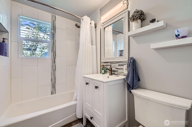 full bath featuring toilet, shower / tub combo, vanity, and decorative backsplash