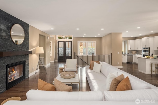 12009 SE 81st Ln, Newcastle, WA 98056 - living room with recessed lighting, dark wood-style flooring, a fireplace, baseboards, and french doors