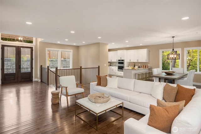 12009 SE 81st Ln, Newcastle, WA 98056 - living room featuring baseboards, recessed lighting, an inviting chandelier, and dark wood-type flooring