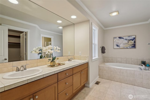 full bath featuring a sink, tile patterned floors, and ornamental molding