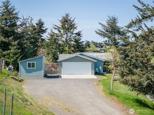 103 Secluded Way, Sequim, WA 98382 - view of front of property featuring fence, an outdoor structure, dirt driveway, and a garage