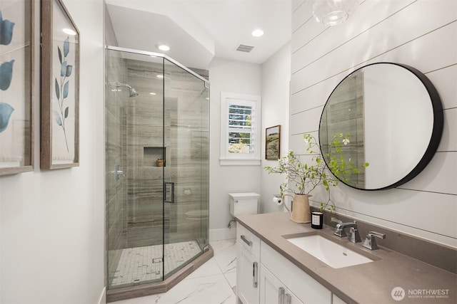 bathroom featuring vanity, recessed lighting, marble finish floor, and a stall shower