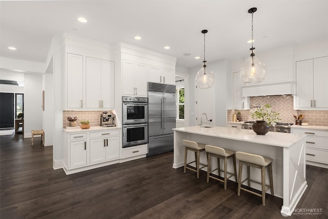 kitchen with backsplash, white cabinetry, appliances with stainless steel finishes, and recessed lighting