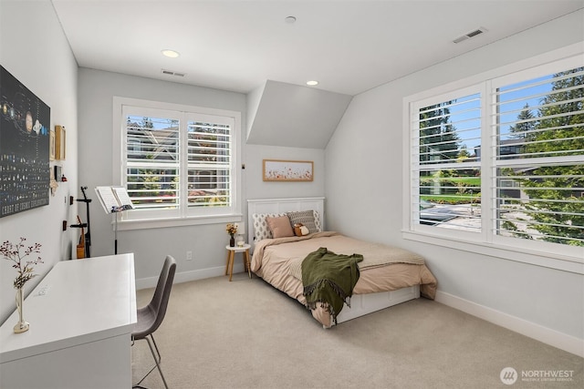 bedroom with visible vents, baseboards, and light carpet