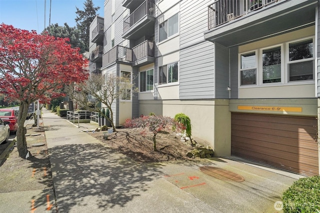 surrounding community with driveway and a garage