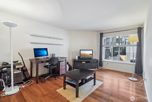 office space with wood finished floors and baseboards