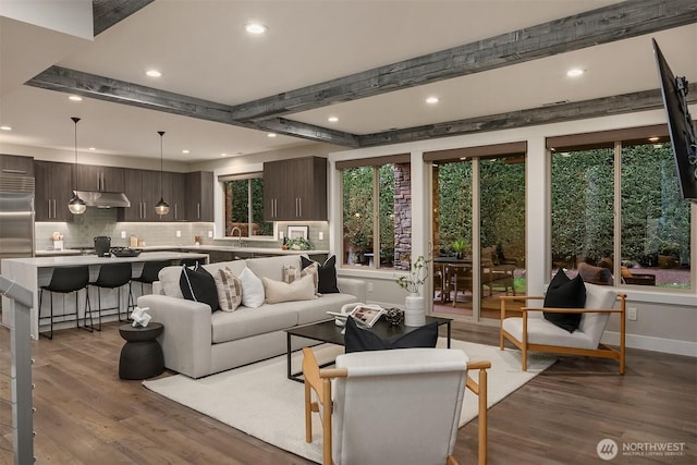 living room with recessed lighting, baseboards, wood finished floors, and beamed ceiling