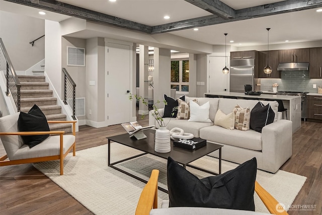 living area with stairs, recessed lighting, baseboards, wood finished floors, and beamed ceiling