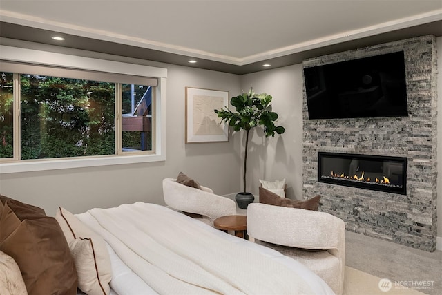 carpeted bedroom with recessed lighting and a stone fireplace