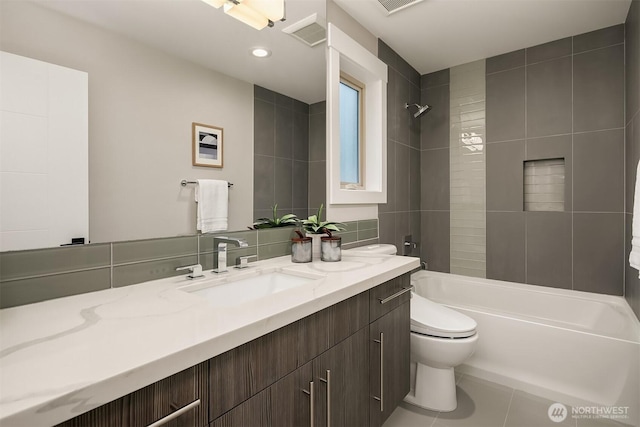 full bathroom with tile patterned flooring, vanity, toilet,  shower combination, and visible vents