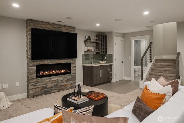living area with light carpet, a fireplace, stairs, recessed lighting, and visible vents