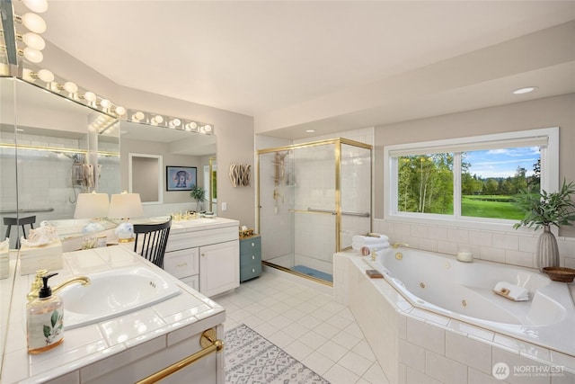 bathroom with a sink, tile patterned floors, a jetted tub, two vanities, and a stall shower
