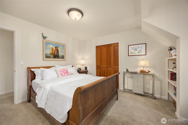 bedroom featuring a closet, carpet flooring, and baseboards