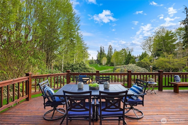wooden terrace with outdoor dining space