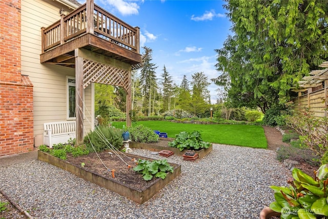 view of yard with a vegetable garden and a deck