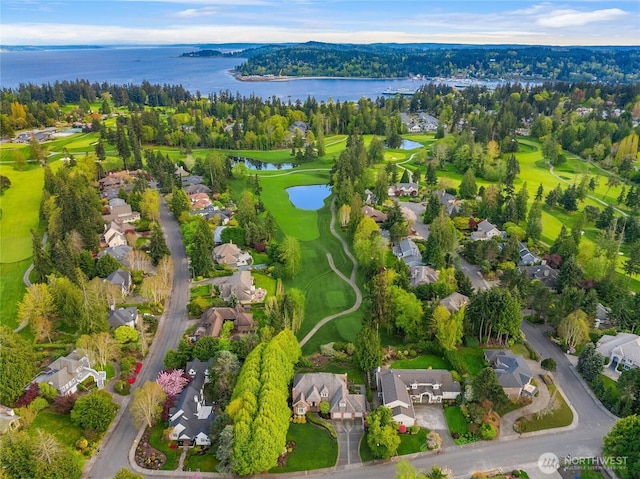 aerial view with a residential view, a water view, and golf course view