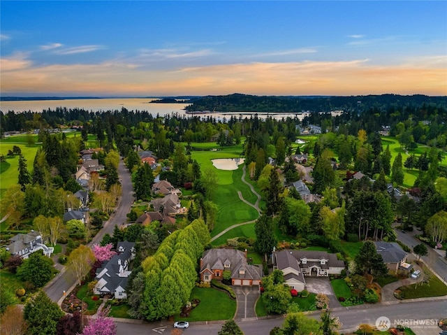 birds eye view of property with a water view, a residential view, and golf course view