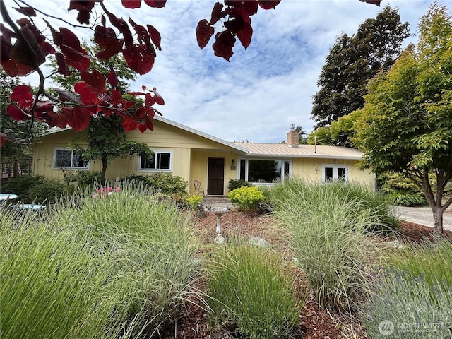 1127 Adams St, Port Townsend, WA 98368 - view of front of house with a metal roof and a chimney