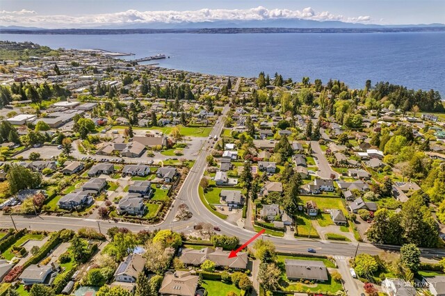 birds eye view of property with a water view and a residential view
