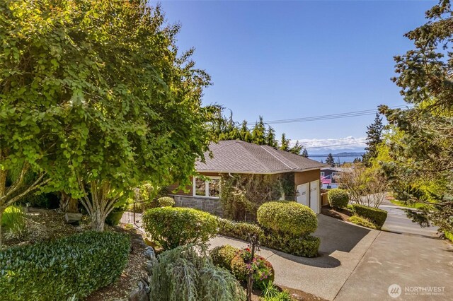 view of side of property with an attached garage and driveway