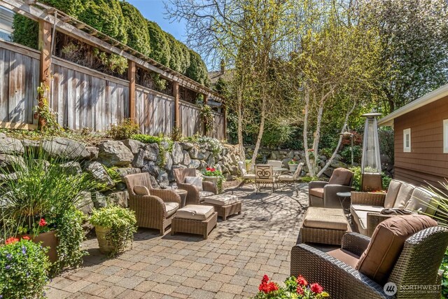 view of patio featuring an outdoor living space and a fenced backyard
