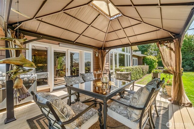 deck with outdoor dining area and a gazebo