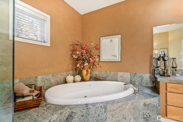 full bathroom featuring vanity and a bath