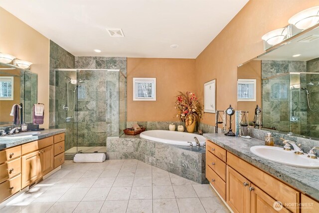 bathroom with a sink, tile patterned floors, a stall shower, and a garden tub