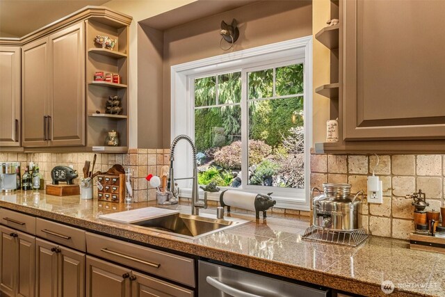 kitchen with stainless steel dishwasher, tile countertops, open shelves, and a sink