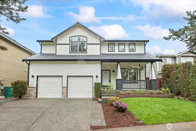 view of front facade featuring an attached garage, a porch, driveway, and a front yard