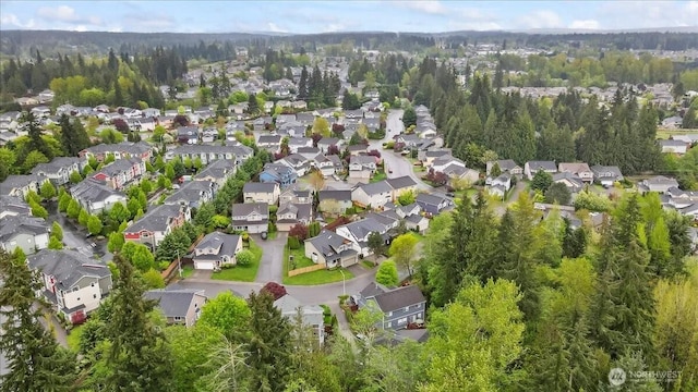 bird's eye view featuring a residential view and a wooded view