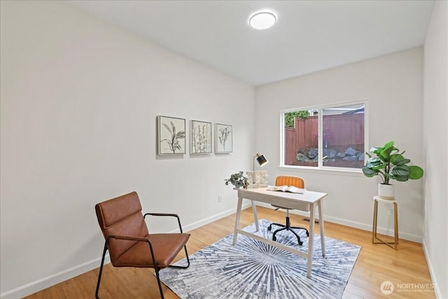 office area with light wood-style floors and baseboards