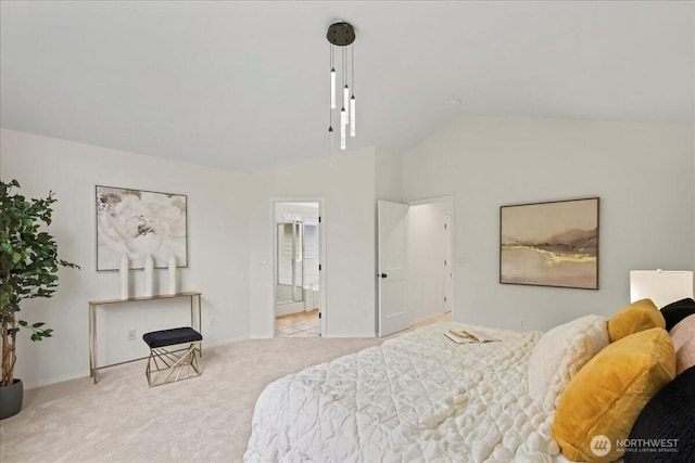 bedroom with baseboards, vaulted ceiling, light carpet, and ensuite bathroom
