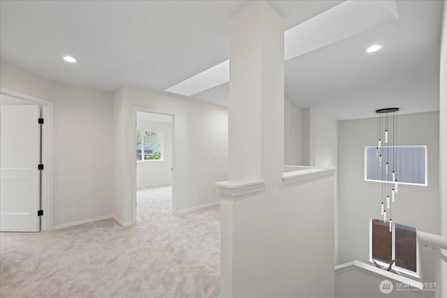 hall featuring carpet floors, baseboards, and recessed lighting