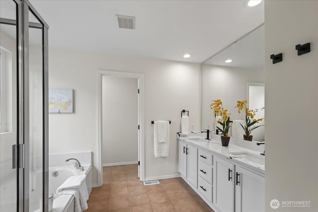 bathroom featuring a garden tub, double vanity, recessed lighting, a sink, and a stall shower