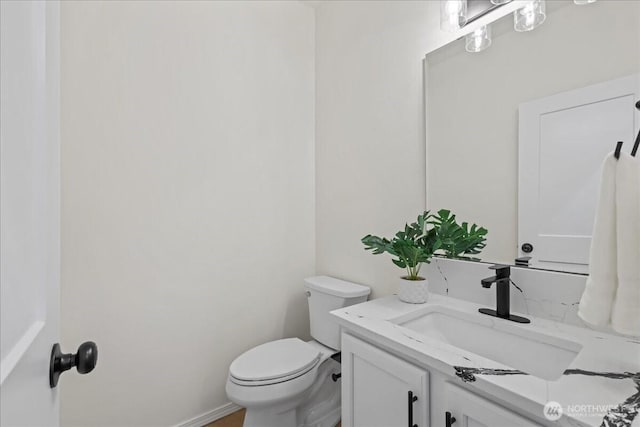 bathroom featuring toilet and vanity