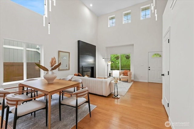dining area featuring a high ceiling and a healthy amount of sunlight