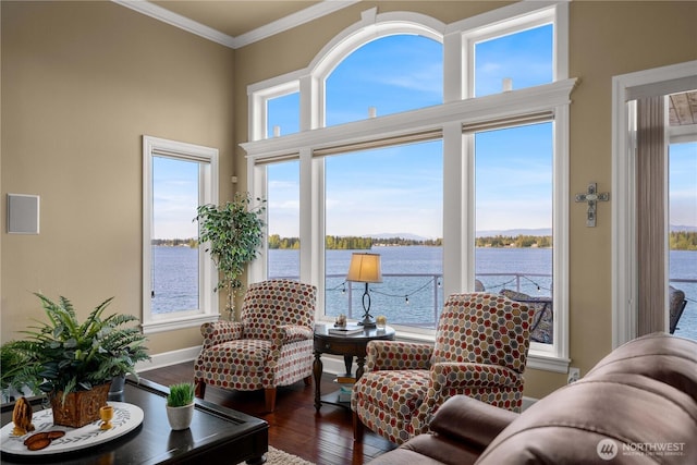 sunroom featuring a water view