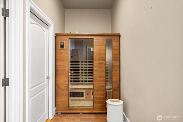 view of sauna featuring wood finished floors and baseboards