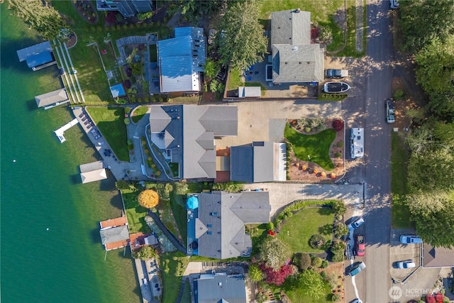 birds eye view of property with a water view