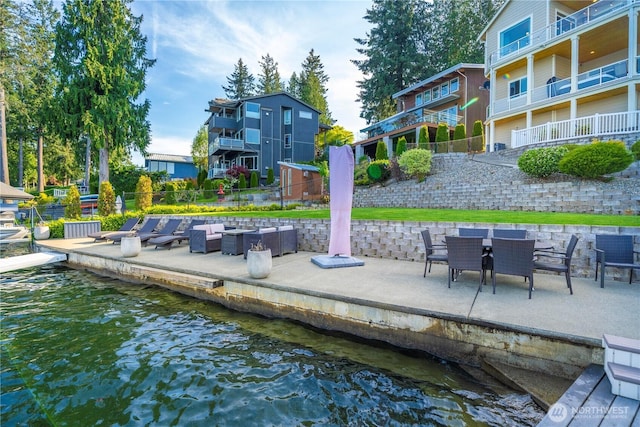 view of dock featuring fence and a water view