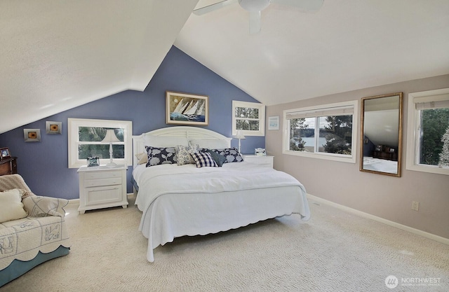 bedroom featuring baseboards, multiple windows, a ceiling fan, and lofted ceiling