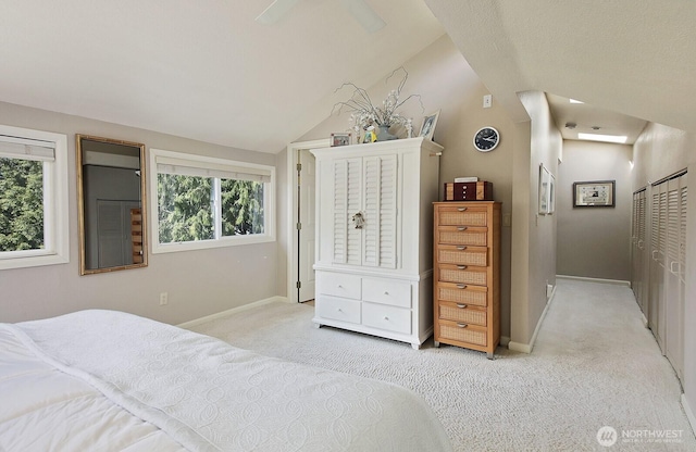 bedroom featuring baseboards, light colored carpet, and multiple windows