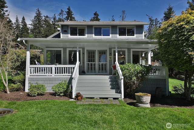 view of front of house with stairs, a porch, and a front lawn